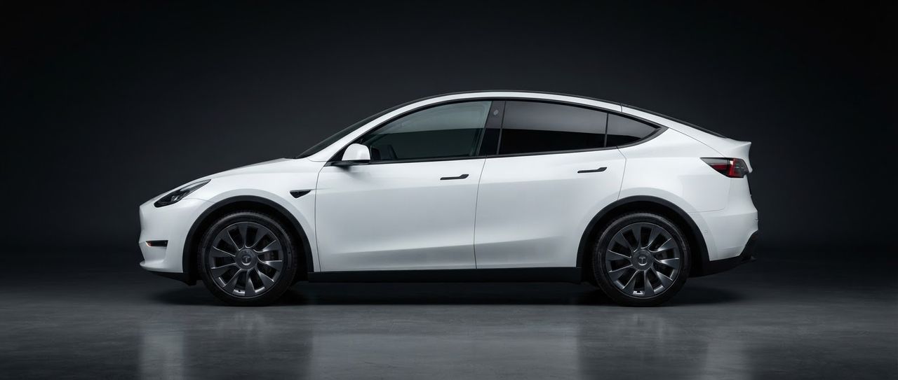 A white Tesla Model Y, photographed side-on